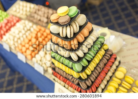 Handmade different colorful macarons pastries arranged in a pyramid.