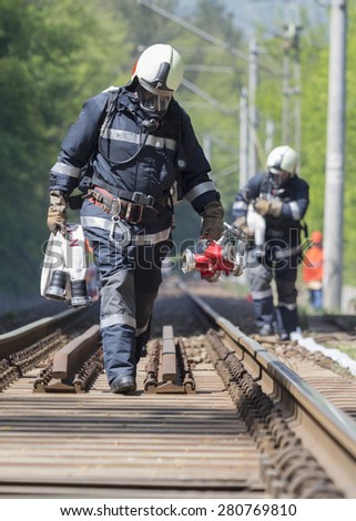 Firefighters are approaching a chemical cargo train crash near Sofia, Bulgaria. Teams from Fire department are participating in an emergency training with spilled toxic and flammable materials.