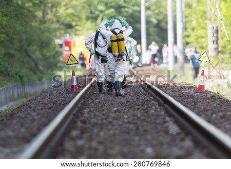 Team working with toxic acid and chemicals is approaching a chemical cargo train crash near Sofia. Teams from Fire department are participating in a training with spilled toxic and flammable materials