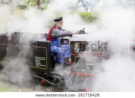 Vienna, Austria - May 2, 2015: Tourists and a train driver enjoy a ride on the so called Liliputbahn. A gauge light railway in the Prater Park.