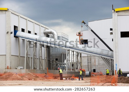 Sofia, Bulgaria - May 29, 2015: Workers are finalizing the construction of Sofia's second waste plant (organic waste plant, waste to energy, composting, incineration, landfill, recycling, windrow).