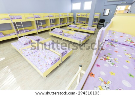Sofia, Bulgaria - June 9, 2015: Modern kindergarten bedroom with small bunk beds with stairs for the kids.