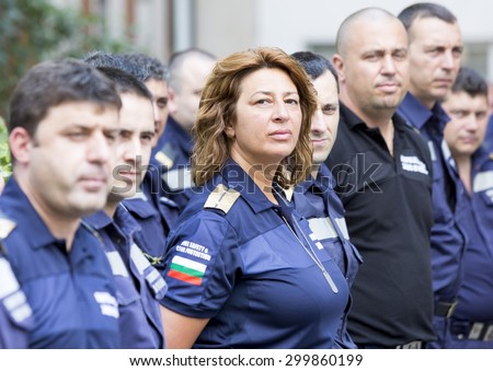 Sofia, Bulgaria - July 15, 2015: A woman firefighter is standing among her colleagues in a line during a awards ceremony.