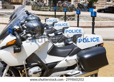 New police motorcycles in line with helmets on them.