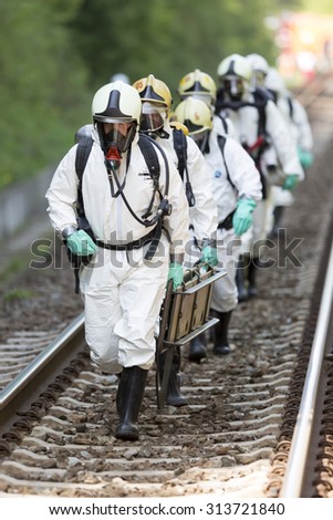 Sofia, Bulgaria - May 19, 2015: A team working with toxic acids and chemicals is approaching a chemical train crash near Sofia. Teams from Fire department are participating in an emergency training.