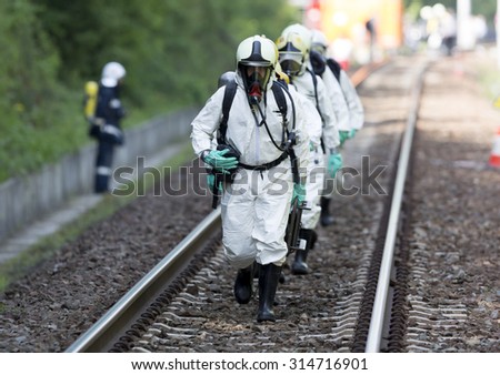 Sofia, Bulgaria - May 19, 2015: A team working with acids and chemicals is approaching a chemical cargo train crash near Sofia. Teams from Fire department are participating in an emergency training.