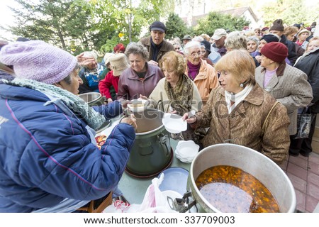 Sofia, Bulgaria - October 26, 2015: Church personnel is giving food to the christian believers who have come to the morning prayer.