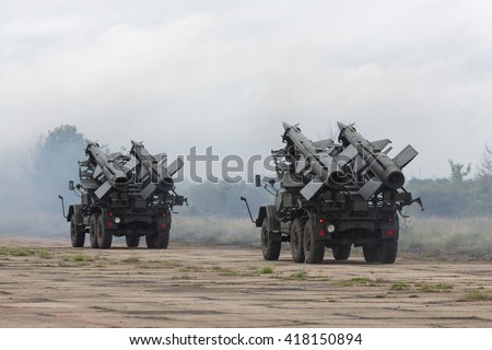 Two mobile antiaircraft missile complexes on trucks, ballistic launcher with missiles ready to attack on military powerful all-terrain transportation. Modern army industry equipment.