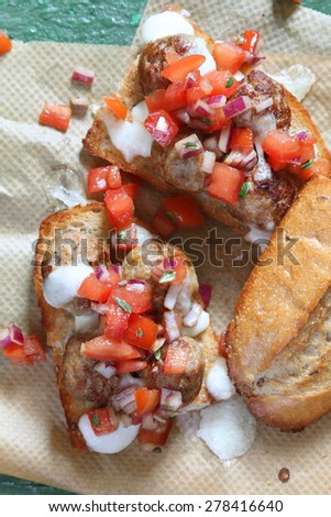 Delicious sandwich: fresh toasted bun with meat balls and tomato salsa of tomatoes and onions, with melting mozzarella