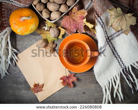 Autumn still life with cup of tea, plaid and leaves. Concept with free text space