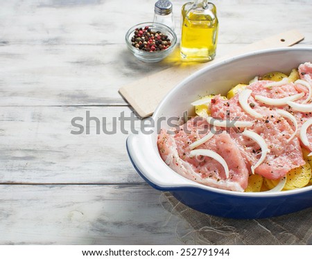 Uncooked casserole with meat, potatoes and cheese. Space for text