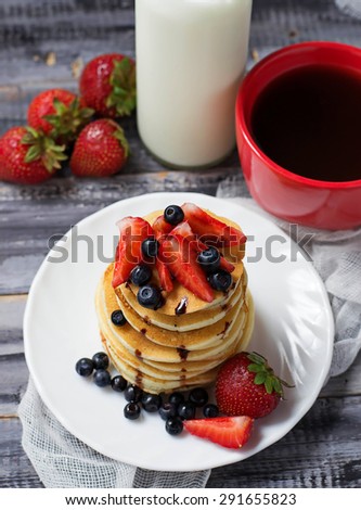 Breakfast with pancakes, coffee and milk. Selective focus
