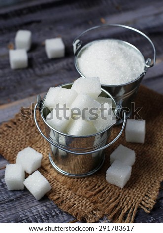 White refined sugar in iron bucket. Selective focus