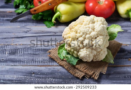 Fresh cauliflower on wooden table with vegetable. Selective focus