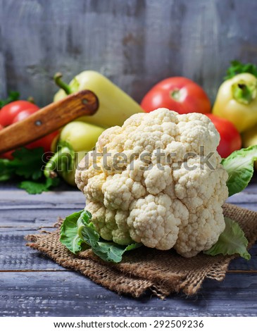 Fresh cauliflower on wooden table with vegetable. Selective focus