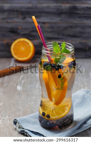 Detox water with orange and blueberry. Selective focus