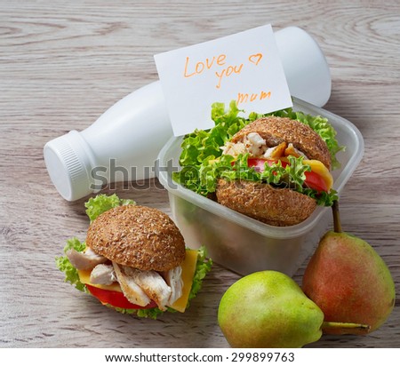 Lunch box with burgers, pears and yogurt. Selective focus