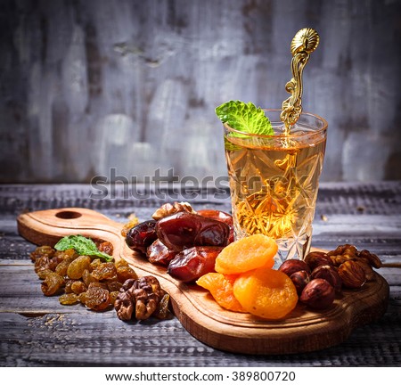 Traditional arabic tea and dry fruits. Selective focus, toned