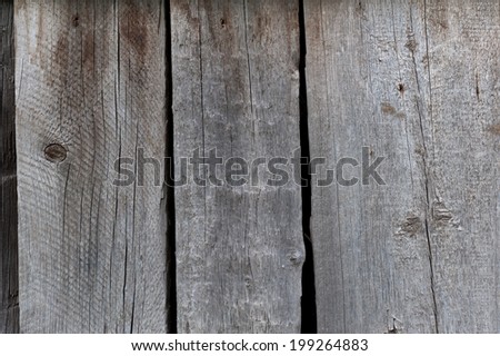 Close-up of an old faded black and grey plank.