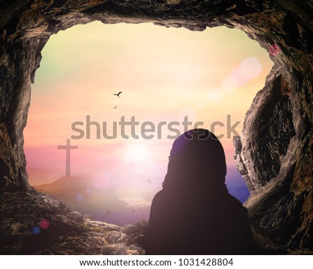 Easter Sunday concept: Jesus Christ is risen from tomb with cross on sunrise background