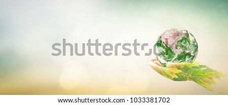 World environment day concept: Double exposure hands of tree and earth global on blurred nature background. Elements of this image furnished by NASA
