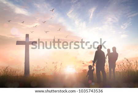 Family worship concept: Silhouette people looking for the cross on autumn sunrise background.