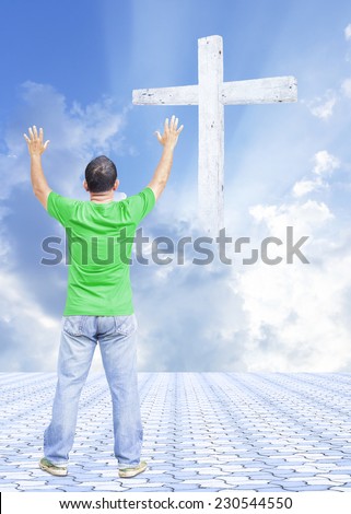 A man raising hands on stone paving over the cross on beautiful sky.