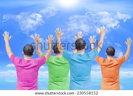 People wearing colorful shirt raising hands on world map of clouds background