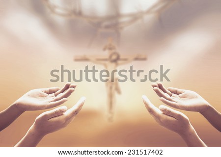 Sepia tone, hands of man praying over blurred crown of thorns and  Jesus with the cross on a sunset.