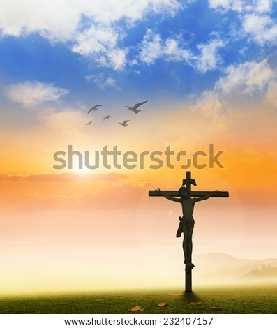 Jesus christ on the white cross over sunset background.
