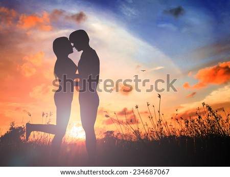 Silhouette couple in love on the sunset. Naked Adam and Eve.