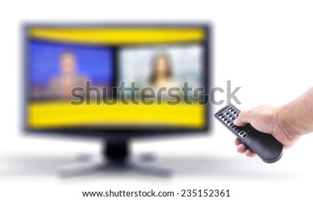 Human hand holding remote and out of focus TV LCD monitor isolated on white.