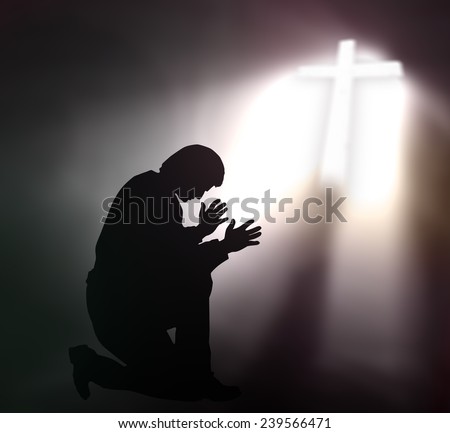 Human kneeling and raising hands over the cross.
