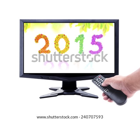 2014-2015 change represents the new year 2015. Human hand holding remote and monitor display the year of the more fruitful on fruitful garden background isolated on white.
