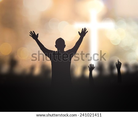 Silhouette people raising hands over blurred the cross on beautiful golden autumn sunset background. Worship, Forgiveness, Mercy, Humble, Repentance, Reconcile, Adoration, Glorify, Redeemer concept.