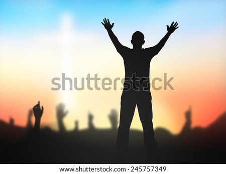 Silhouette people raising hands over blurred crown of thorns and the white cross on nature background.