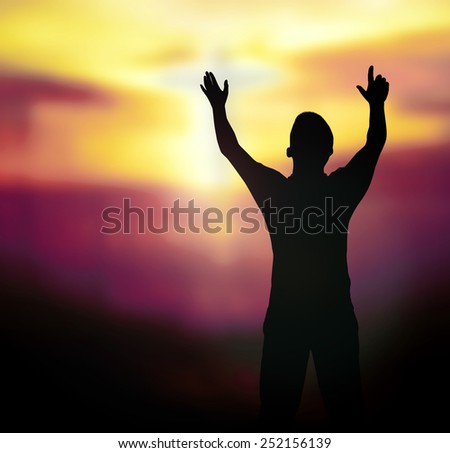 Silhouette human raising hands over blurred the white cross on nature background.