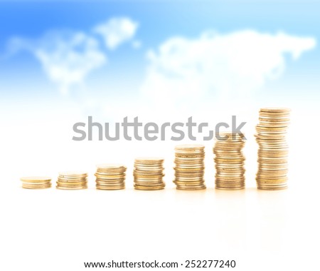 Stacks of golden coins over world map of clouds background. Money coin concept.