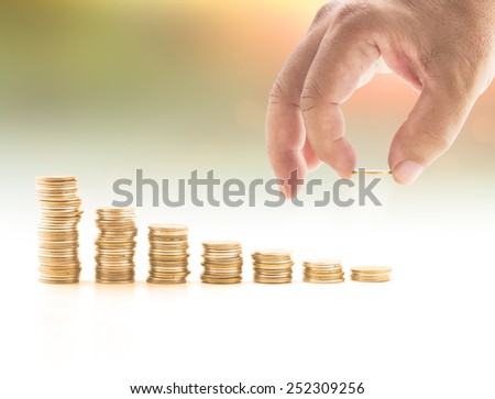 Human hand adding or removing a golden coin in the final row over blurred the city. Debt, Money coin, Investment, Insurance Agent, Banking, Saving, Trust, LIT, Planing, Management concept.