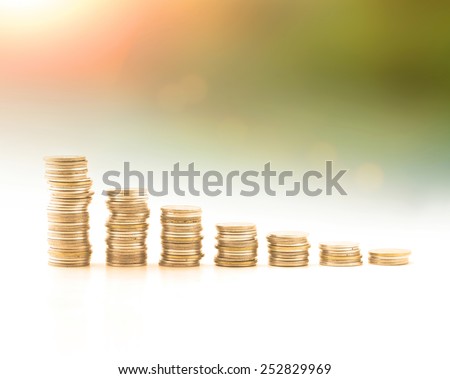 Stacks of golden coins over world map of clouds background. Money coin concept.