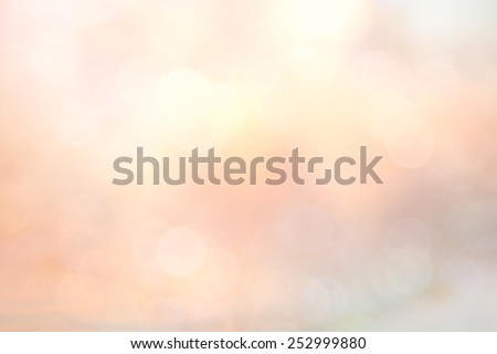 Abstract blurred textured background: orange and pink patterns. Blurred autumn sunset background. Sandy beach backdrop with turquoise water and bright sun light. Summer holidays concept.