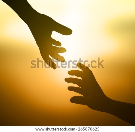 Silhouette hand of a man reaching to hand of GOD, or hand holding puzzle over beautiful  the beach sunrise or sunset background.