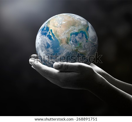 Planet in black and white human hands on nature background. environment concept. Elements of this image furnished by NASA.