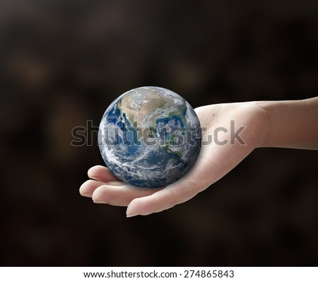 Planet in human hands on nature background. environment concept. Elements of this image furnished by NASA.