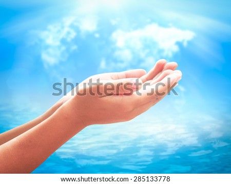Human open empty hands with palms up over blurred world map of clouds and beautiful ocean background. Environment concept. Pray for support concept.