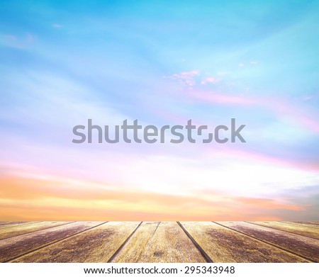 Wooden paving and abstract soft and beautiful sky textured background: yellow pink and blue patterns.