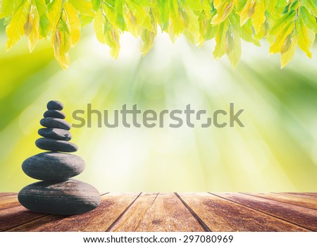 Balanced seven Zen stones on wooden paving and blurred beautiful nature background.