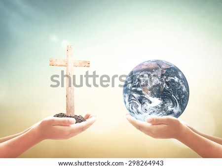 First, human hands holding the white cross. Second, human hands holding Blue planet over nature background. Elements of this image furnished by NASA.