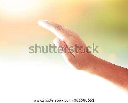 Human hand praying to other people over night light background.