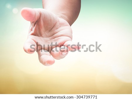 Human hand open empty hands with palms up over blurred nature, gesture of asking for the help or reach for helping someone who is troubled. Pray for support concept. Established principle concept.